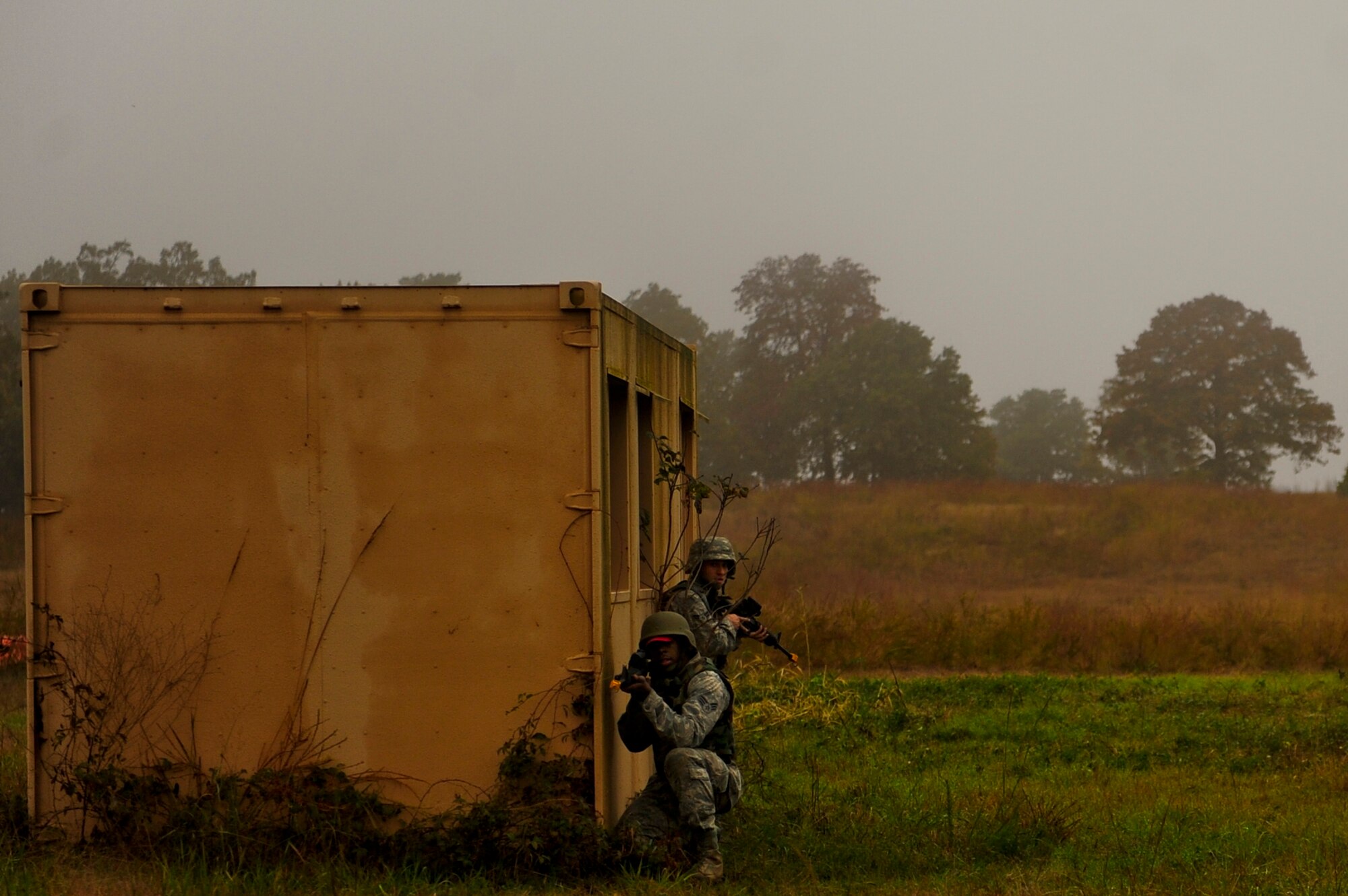 Senior Airman Bradley Lowery (front) and Airman 1st Class Xian Santiago, both with the 567th RED HORSE out of Seymour Johnson Air Force Base, North Carolina, provide cover during a field training exercise at Fort Smith, Arkansas, Nov. 5, 2014. The weeklong exercise, also featuring the 560th RED HORSE out of Joint Base Charleston, South Carolina, and Airmen out of the 4th Fighter Wing at Seymour Johnson AFB, is hosting 174 participants to provide upgrade training and prepare for an upcoming operation in support of Beyond the Horizon. Beyond the Horizon, conducted annually, is part of U.S. Army South and U.S. Southern Command’s humanitarian and civic assistance program, which works closely with host-nation forces and civilian organizations to provide medical, dental, and engineering support. (U.S. Air Force photo/Airman 1st Class Brittain Crolley)