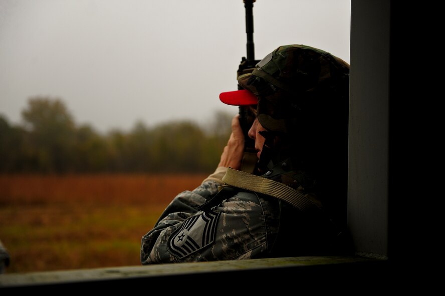 Chief Master Sgt. Ilinka Kocis, with the 567th RED HORSE out of Seymour Johnson Air Force Base, North Carolina, takes cover behind a building during a field training exercise at Fort Smith, Arkansas, Nov. 5, 2014. The weeklong exercise, also featuring the 560th RED HORSE out of Joint Base Charleston, South Carolina, and Airmen out of the 4th Fighter Wing at Seymour Johnson AFB, is hosting 174 participants to provide upgrade training and prepare for an upcoming operation in support of Beyond the Horizon. Beyond the Horizon, conducted annually, is part of U.S. Army South and U.S. Southern Command’s humanitarian and civic assistance program, which works closely with host-nation forces and civilian organizations to provide medical, dental, and engineering support. (U.S. Air Force photo/Airman 1st Class Brittain Crolley)