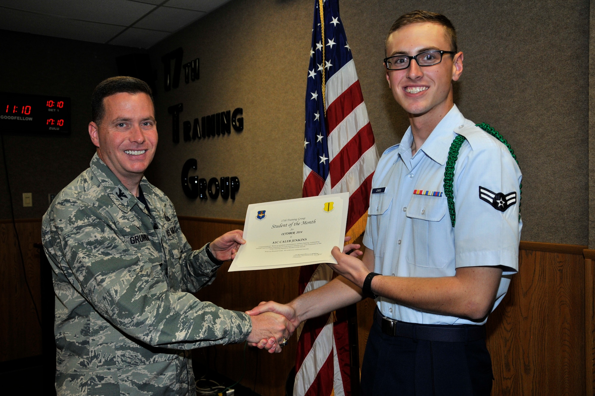 GOODFELLOW AIR FORCE BASE, Texas -- Col. Michael Grunwald Jr., 17th Training Group Commander, presents the 315th Training Squadron Enlisted Student of the Month award for October 2014 to Airman 1st Class Caleb Jenkins, Nov. 7.  (U.S. Air Force photo/ Airman 1st Class Scott Jackson)