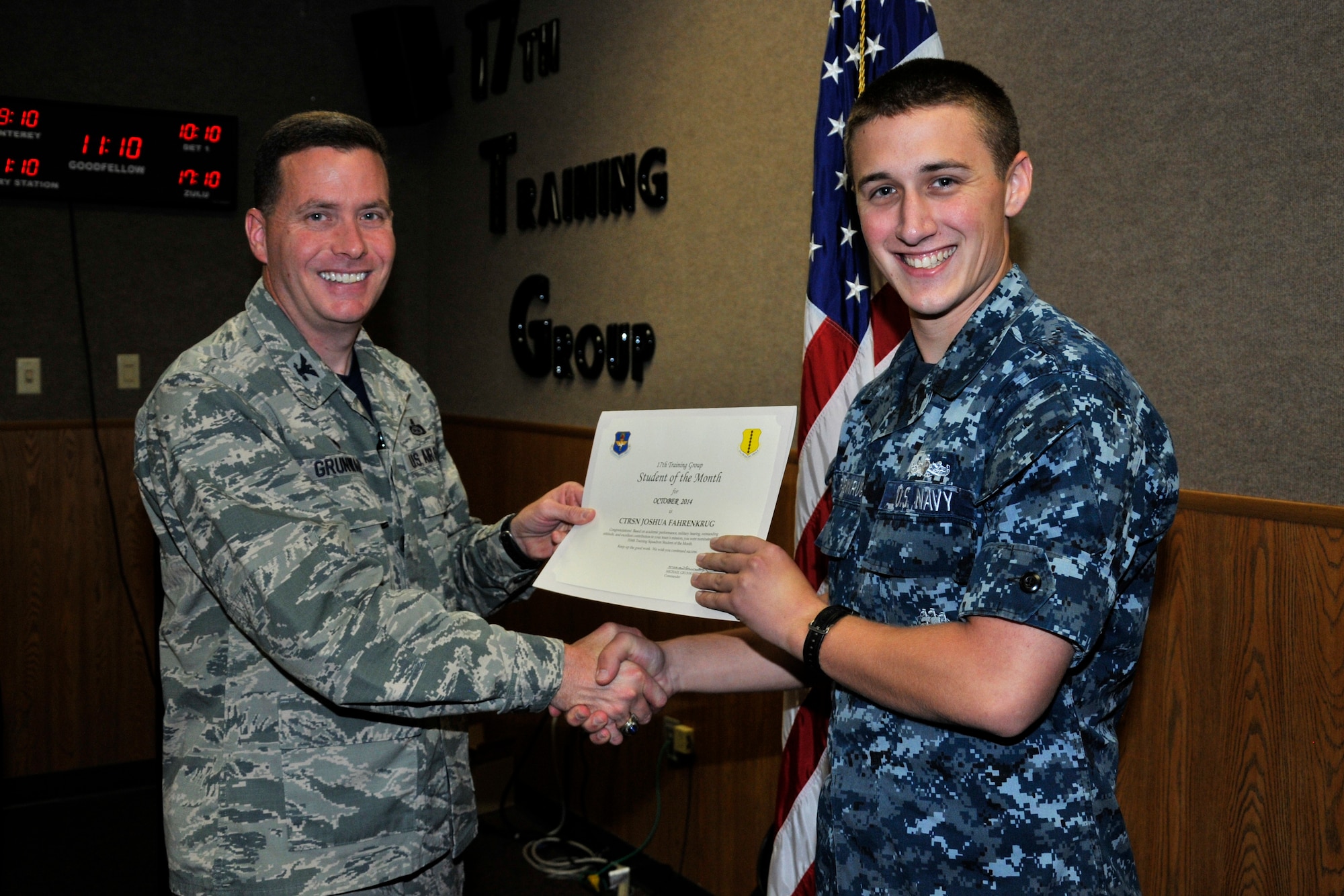 GOODFELLOW AIR FORCE BASE, Texas -- Col. Michael Grunwald Jr., 17th Training Group Commander, presents the 316th Training Squadron Enlisted Student of the Month award for October 2014 to Navy Seaman Joshua Fahrenkrug, Nov. 7.  (U.S. Air Force photo/ Airman 1st Class Scott Jackson)