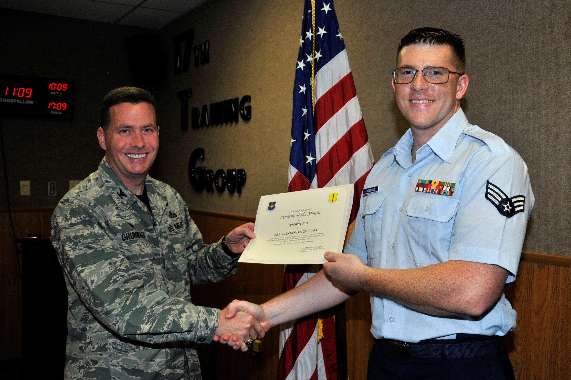 GOODFELLOW AIR FORCE BASE, Texas -- Col. Michael Grunwald Jr., 17th Training Group Commander, presents the 312th Training Squadron Enlisted Student of the Month award for October 2014 to Senior Airman Brendon Fitzgerald, Nov. 7.  (U.S. Air Force photo/ Airman 1st Class Scott Jackson)