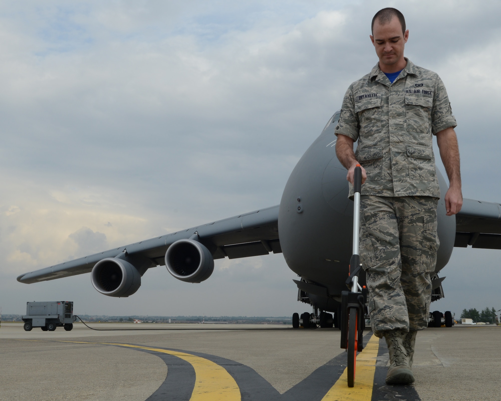 Senior Airman Christopher Defayette, 39th Operations Support Squadron airfield management shift lead, measures a section of the flightline Oct. 24, 2014, Incirlik Air Base, Turkey. Airfield management plays a crucial role in maintaining flight operations for the base. (U.S. Air Force photo by Staff Sgt. Caleb Pierce/Released) 