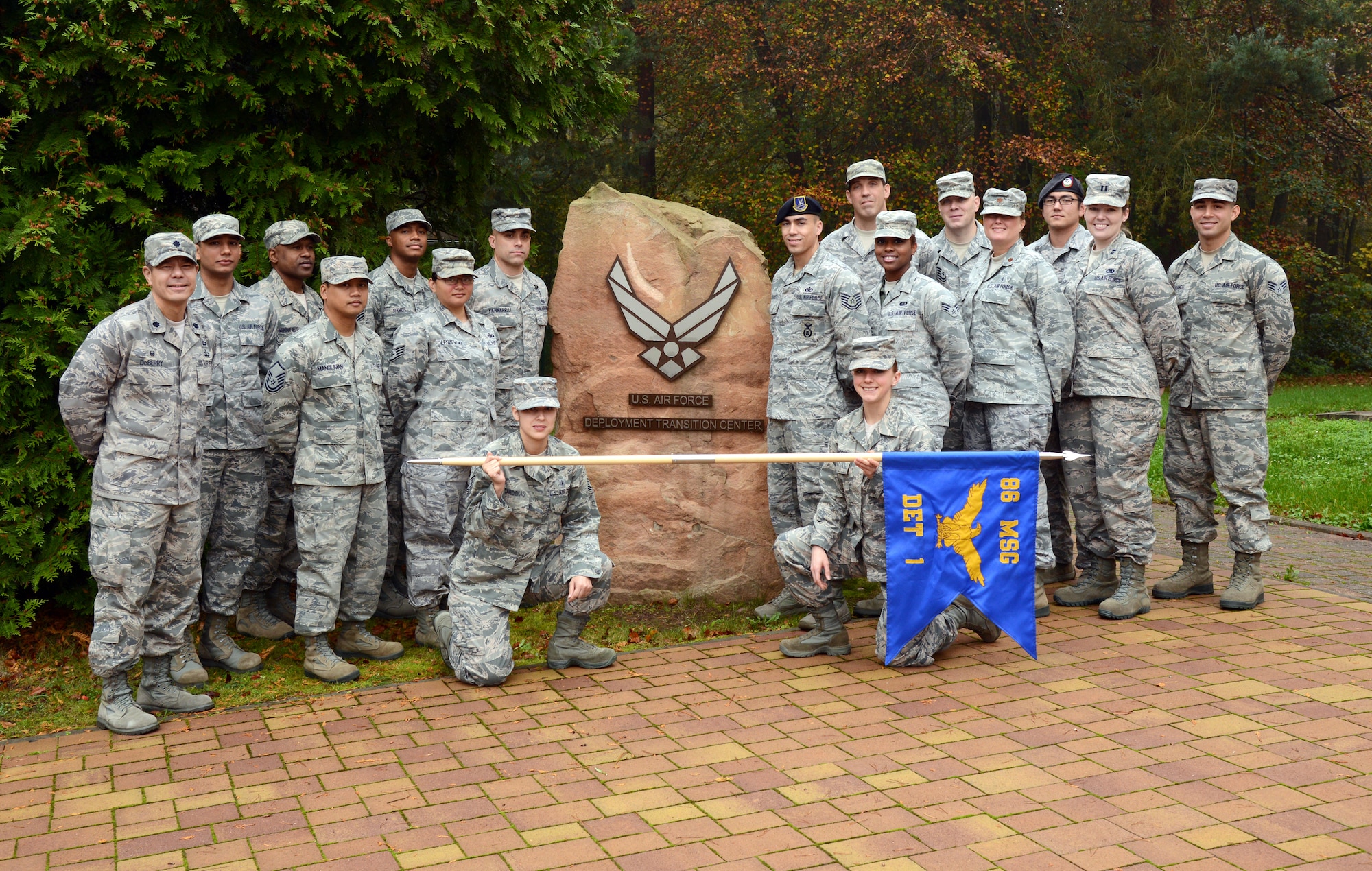 The Air Force Deployment Transition Center staff poses for a group photo in front of their building on Ramstein Air Base, Germany, Oct. 30, 2014. The DTC staff is comprised of Airmen from the Air Force specialty codes that the center was originally stood up to help transition from downrange to home. (U.S. Air Force photo/Senior Airman Timothy Moore)