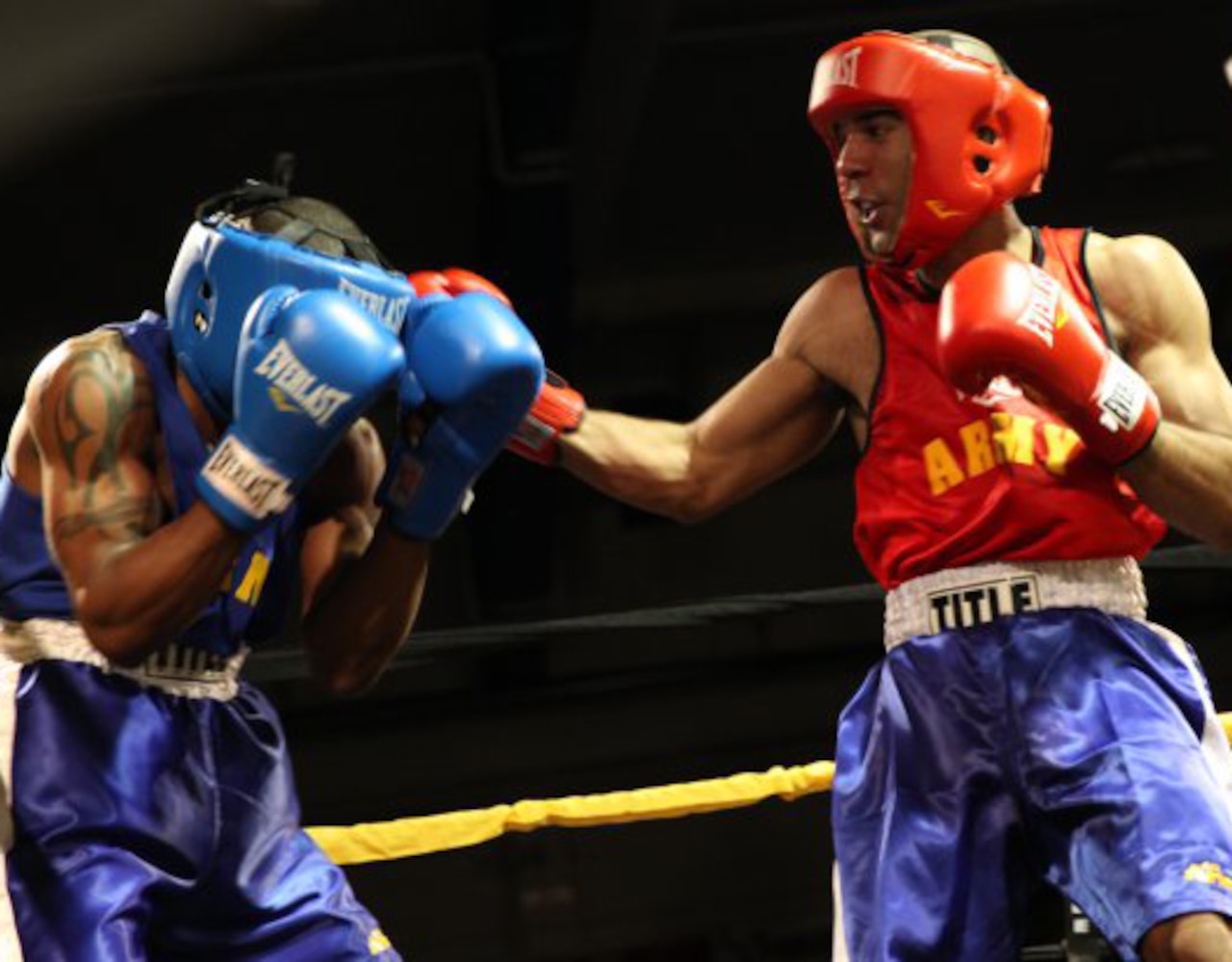 Current All-Army light weatherweight boxing champ, then-Spc. Anthony Nunez, right, delivers a right hook to Spc. Adrian McKinney during the 2013 All-Army Boxing Championships at the Barnes Field House at Fort Huachuca, Ariz., March 9, 2013. U.S. Army photo by Sgt. Robert England