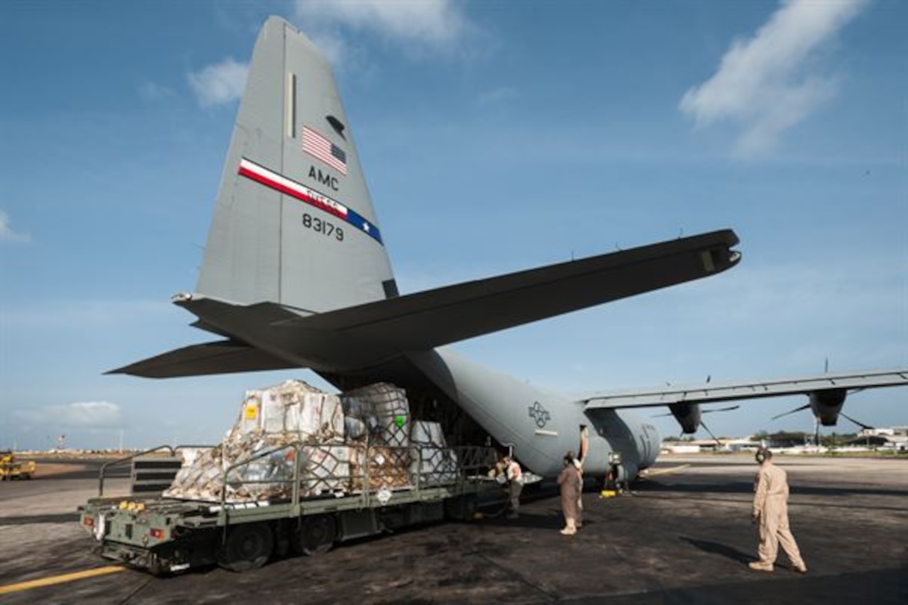Aerial porters from the Kentucky Air National Guard’s 123rd Contingency Response Group load eight tons of humanitarian aid and military supplies onto a U.S. Air Force C-130 aircraft at Léopold Sédar Senghor International Airport in Dakar, Senegal, Nov. 4, 2014. The aircraft and crew, from Dyess Air Force Base, Texas, are deployed to Senegal as part of the 787th Air Expeditionary Squadron, and will fly the cargo into Monrovia, Liberia, in support of Operation United Assistance, the U.S. government’s effort to contain the Ebola virus outbreak in West Africa. U.S. Air Force photo by Maj. Dale Greer