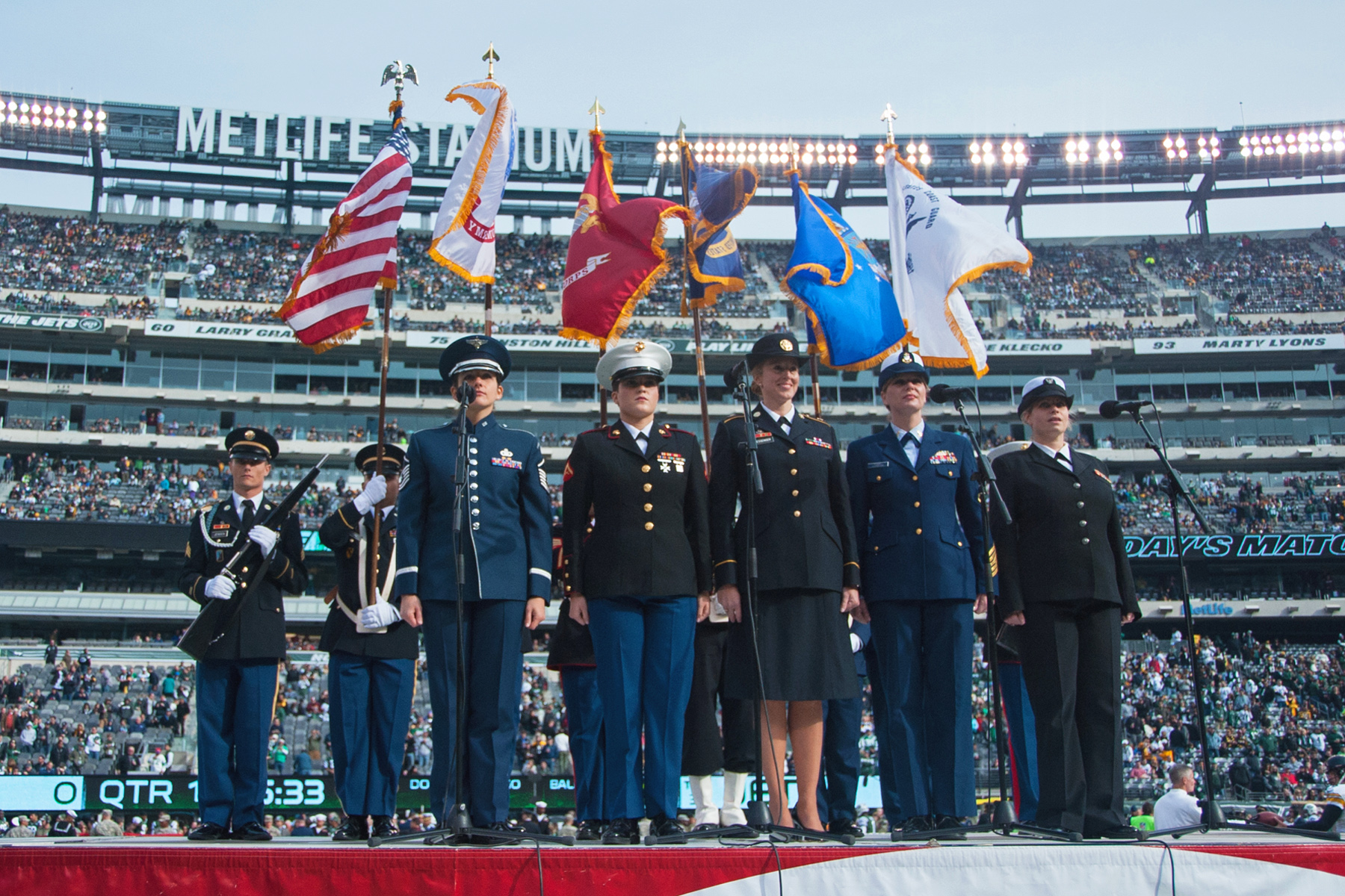 Vocalists from each military branch perform the national anthem during the New  York Jets' Salute to