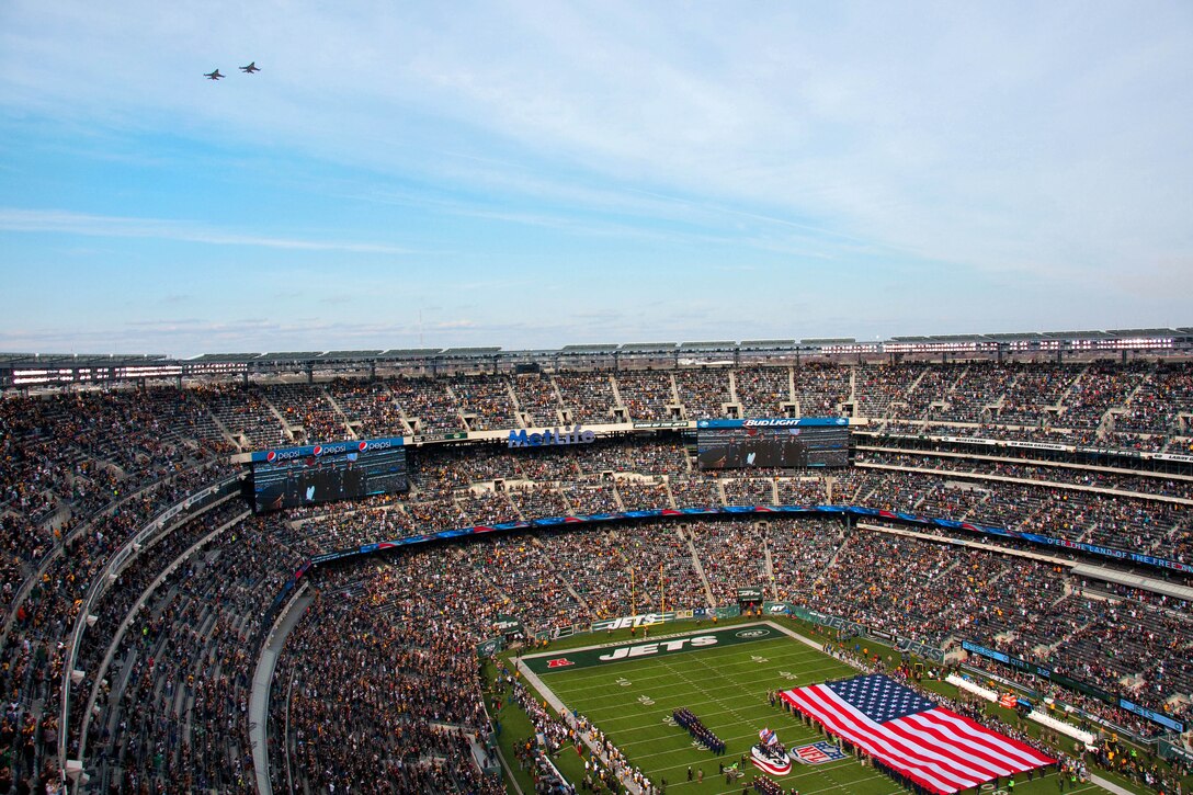 F-16 Fighting Falcons fly overhead during the New York Jets’ Salute to Service game at MetLife Stadium in East Rutherford, N.J., Nov. 9, 2014. The pilots are assigned to the New Jersey Air National Guard's 177th Fighter Wing.
