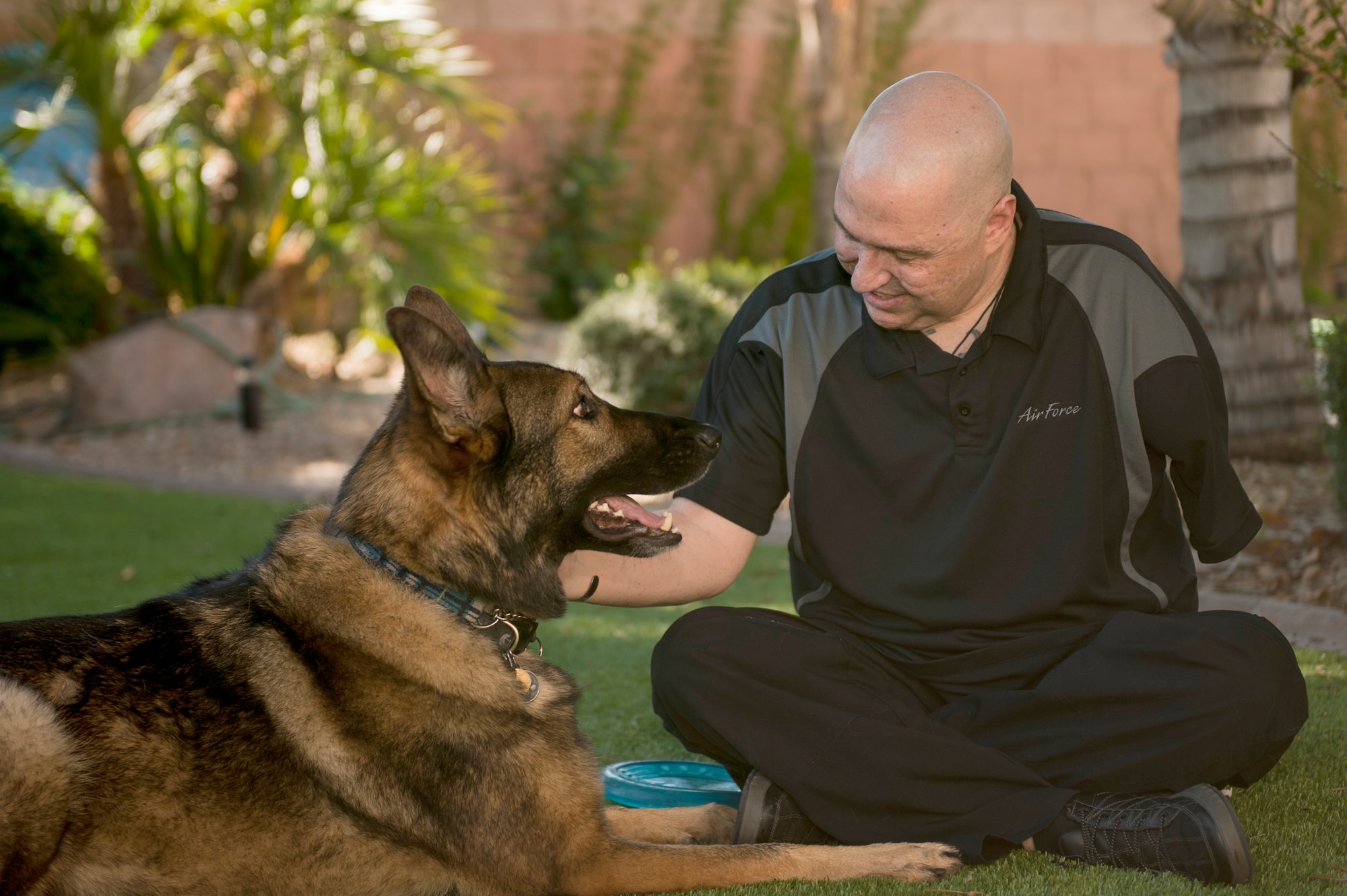 Retired Tech. Sgt. Matthew Slayton plays with Legend, his guide dog, Oct. 24 at his home near Luke Air Force Base. Slaydon received Legend in October 2010 from Fidelco Guide Dogs, a nonprofit organization. (U.S. Air Force photo/Staff Sgt. Staci Miller)
