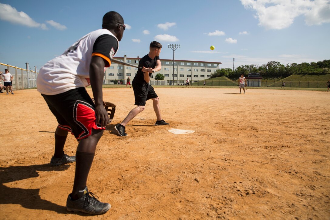 CAMP HANSEN, Japan – Marines compete in a softball game here, Nov. 10. Following a Marine Corps birthday celebration, the Marines of Battalion Landing Team 3rd Battalion, 5th Marines, 31st Marine Expeditionary Unit, held a battalion-wide competition pitting the companies against each other in flag football, basketball, softball, tug of war and more. The winner of the competition was Company K and their award is to be the first company to return home to California before the rest of the battalion. (U.S. Marine Photo by Cpl. Henry Antenor)
