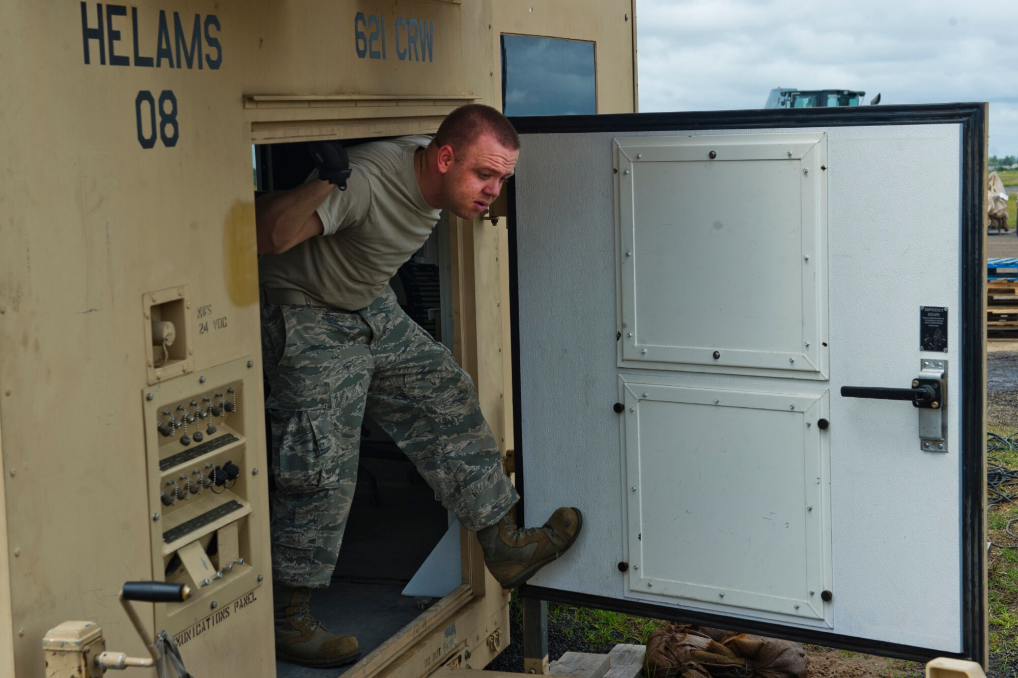 U.S. Air Force Senior Airman Derek Brittain from the Joint Task Force-Port Opening assigned to the 621st Contingency Response Wing stationed at Joint Base McGuire-Dix-Lakehurst, N.J., walks through a compartment of a Hard-sided Expandable Lightweight Air Mobile Shelter as he prepares equipment for re-deployment after completing their mission at Roberts International Airport, Republic of Liberia, during Operation UNITED ASSISTANCE, Nov. 9, 2014. The JTF-PO established a hub for cargo distribution to help alleviate the increased traffic of airflow and cargo during OUA, a Department of Defense operation in Liberia to provide logistics, training and engineering support to U.S. Agency for International Development-led efforts to contain the Ebola virus outbreak in western Africa. (U.S. Air Force photo/Staff Sgt. Gustavo Gonzalez/RELEASED)