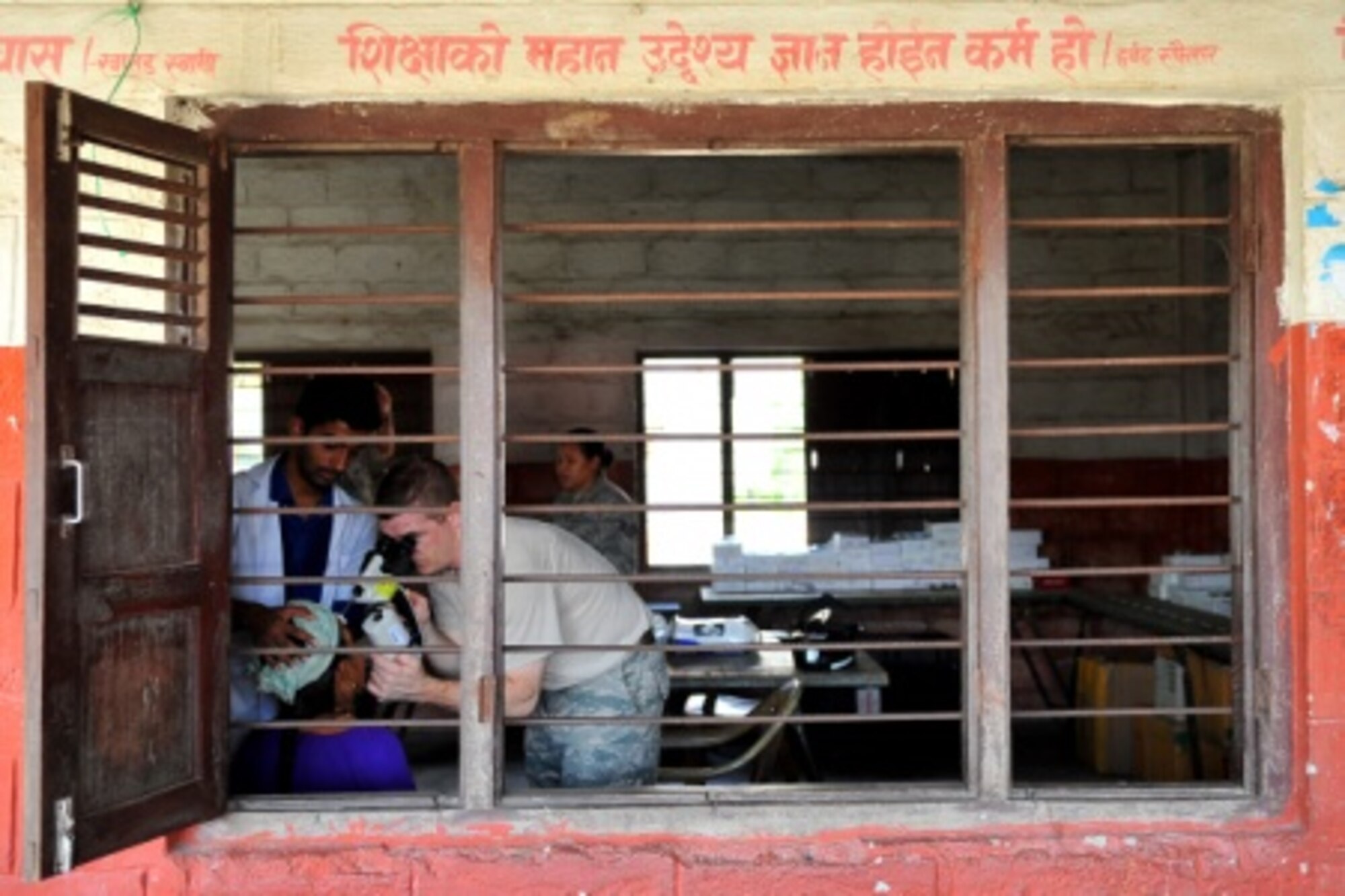 U.S. Air Force Maj. Robert D. Groves and Nepalese optometry professionals assess patients for additional care at a health services outreach site in Manahari, Nepal, Sept. 8, 2014. Operation PACANGEL helps cultivate common bonds and foster goodwill between the U.S., Nepal and regional nations by conducting multilateral humanitarian assistance and civil military operations. (U.S. Air Force photo by Staff Sgt. Melissa B. White/Released)
