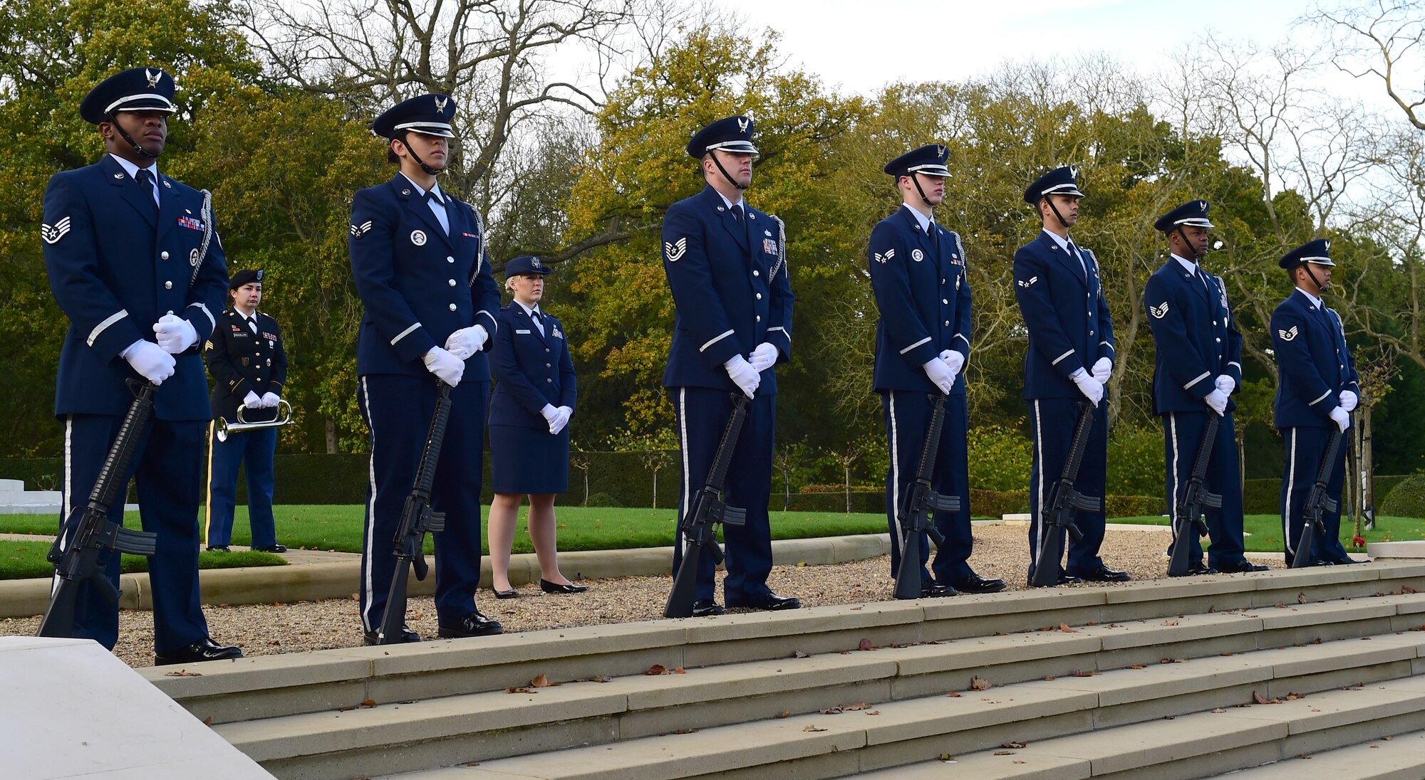 Members of the 423rd Air Base Group Honor Guard stand at parade rest during a Veterans Day ceremony at Cambridge American Cemetery, United Kingdom, Nov. 11, 2014. The Honor Guard paid tribute to Service members both past and present with a volley and the playing of Taps. (U.S. Air Force photo by Tech. Sgt. Chrissy Best/Released)