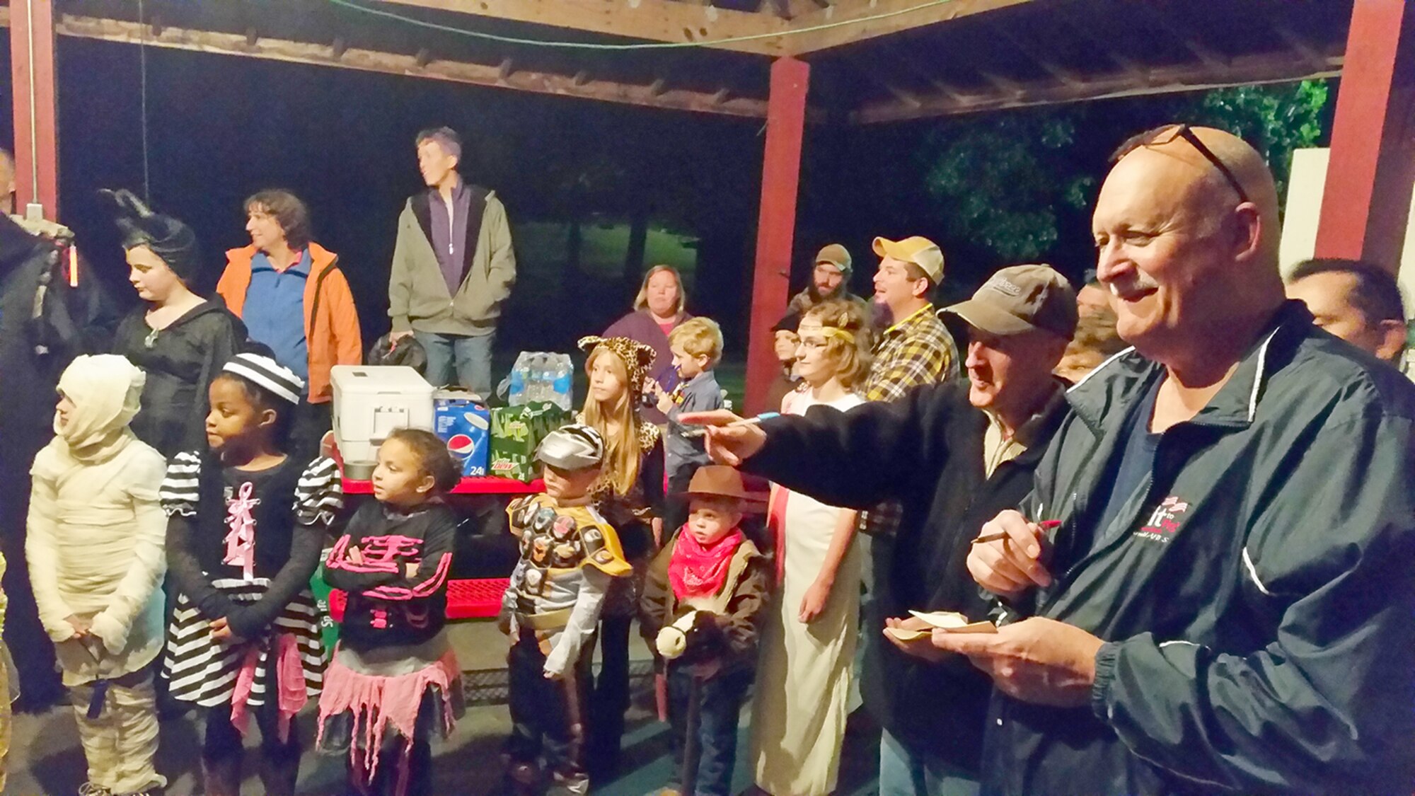Judges Col. James Krajewski (second from right) and Ron Stephenson (right) discuss the scoring of contestants’ costumes at the Arnold Services Office Fright Fest Costume contest on Oct. 18. (Photo provided)