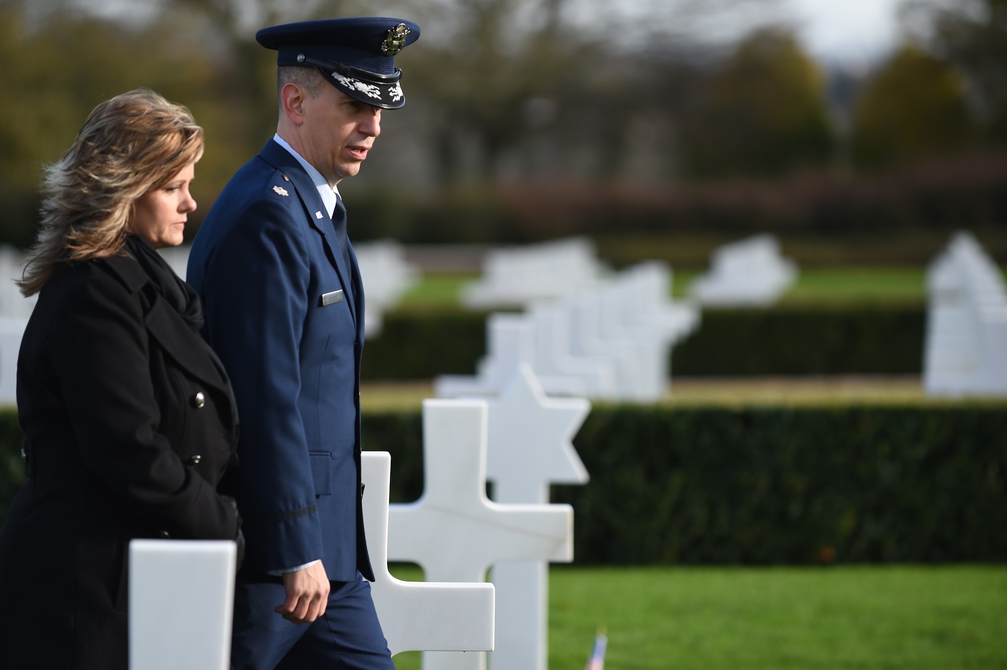 U.S. Air Force Lt. Col. Peter Fischer, 501st Combat Support Wing chaplain, and his wife, Shannon, 501st CSW secretary, walk through a row of tombstones at Cambridge American Cemetery, United Kingdom,  Nov. 11, 2014. Prior to the Veterans Day ceremony, the Fischers explored the grounds – looking for graves of fallen family members. (U.S. Air Force photo by Staff Sgt. Jarad A. Denton/Released)