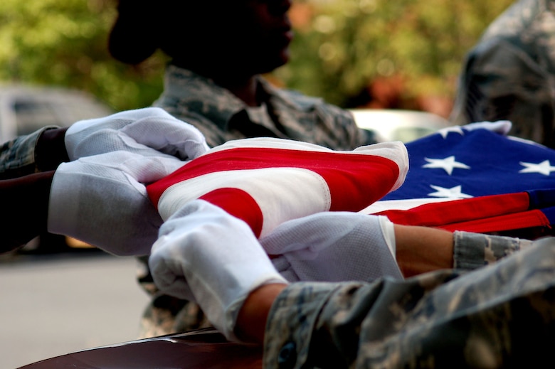 Six U.S. Air Force members of 145th Airlift Wing Honor Guard, fold a flag during honor guard training at the North Carolina Air National Guard base, Charlotte Douglas Intl Airport. Through obstacles and emotions, honor guard members must work to complete the detail while keeping their military bearing. (U.S. Air National Guard photo by Master Sgt. Patricia F. Moran, 145th Public Affairs/Released)