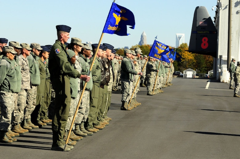 With a view of the Charlotte skyline in the background, Airmen from the 145th Airlift Wing, muster and report to base commander, Col. Marshall C. Collins, during a traditional ramp formation held at the North Carolina Air National Guard base, Charlotte Douglas Intl. Airport, Nov. 2, 2014. (U.S. Air National Guard photo by Master Sgt. Patricia F. Moran, 145th Public Affairs/Released)