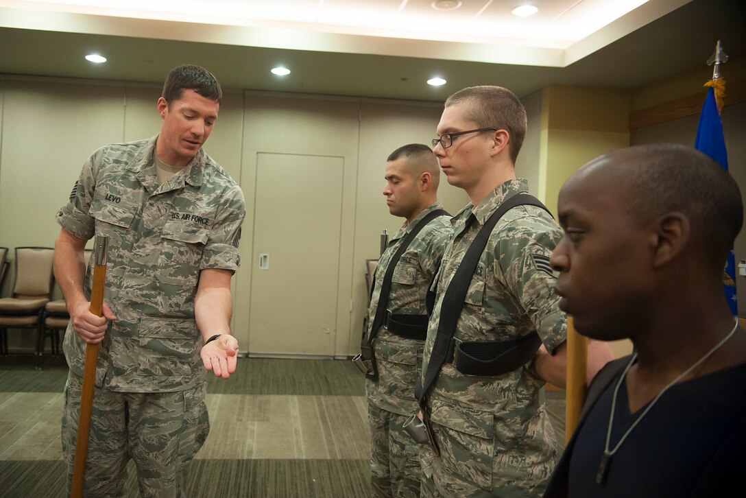 Tech. Sgt. Brian Levo, 51st Operations Support Squadron operations analyst, leads posting of the colors practice during Honor Guard practice at Osan Air Base, Republic of Korea, Oct. 30, 2014. The Osan Honor Guard performs cordons for arrival and departure ceremonies, formal retreat ceremonies, dining-ins and outs, retirements, and change of command ceremonies. (U.S. Air Force photo by Senior Airman Matthew Lancaster)