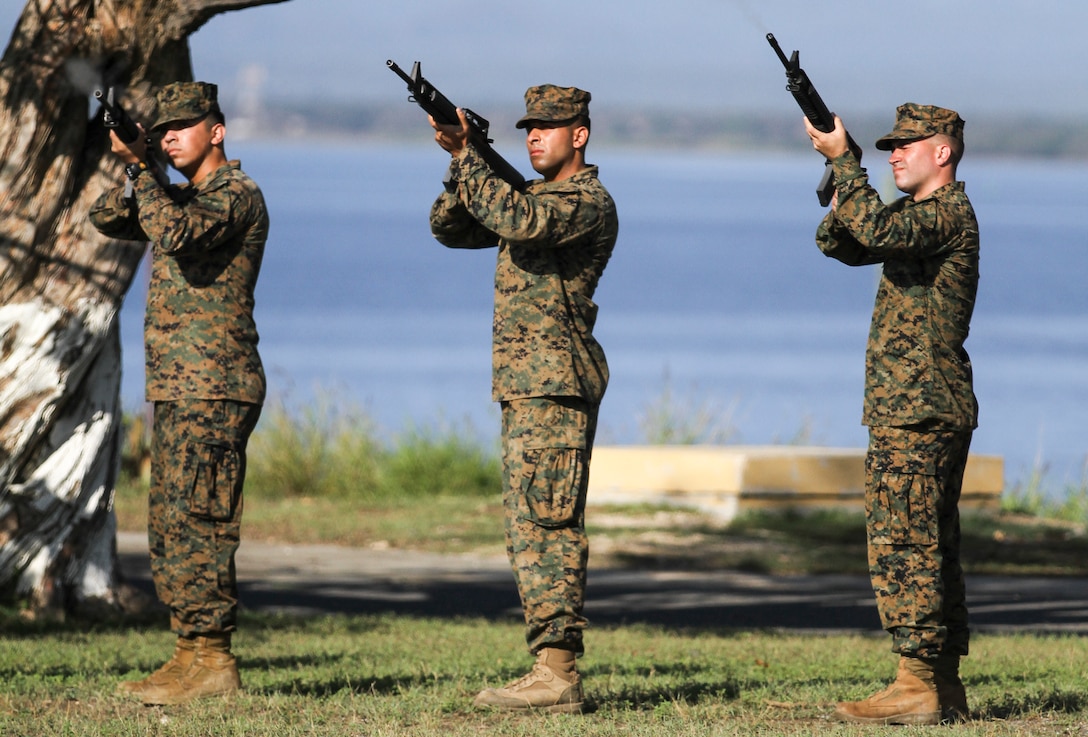 Members of the 21-gun salute team fire a volley of blank ammunition during the Veterans Day ceremony at U. S. Naval Station Guantanamo, Cuba, Nov. 11, 2014.