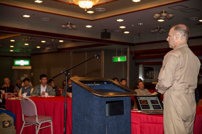 Maj. Edward Bahret, the aviation safety officer for Marine Corps Air Station Iwakuni, Japan, speaks to Japanese aviators during a flight security conference inside Club Iwakuni aboard station, Nov. 1, 2014. The conference allowed for a unique gathering of Japanese civilians and U.S. military members for the common benefit of aviation safety.