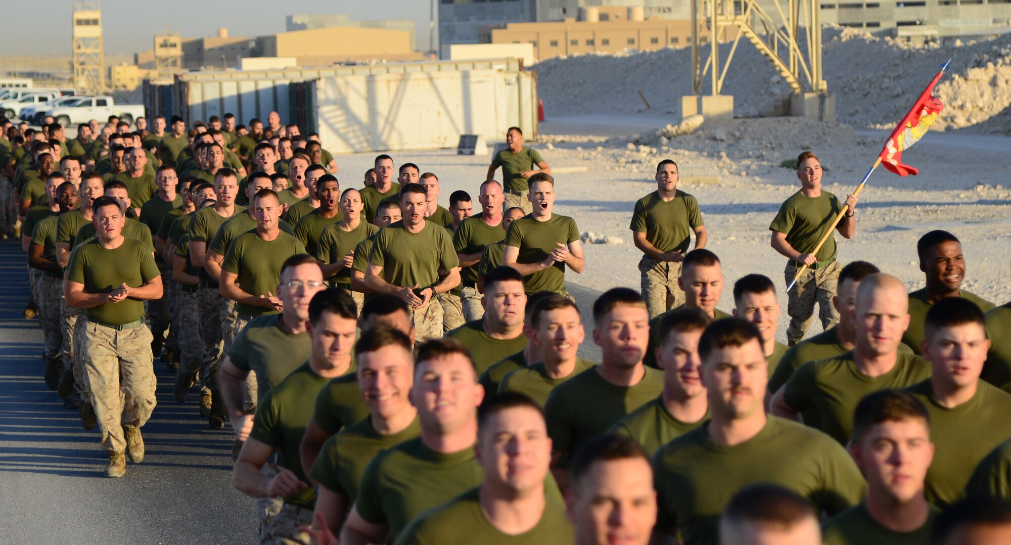 U.S. Marines from the Marine Tactical Electronic Warfare Squadron 4 (VMAQ-4) run in formation for the final two-mile stretch of a 239-mile Marine Corps flag relay run Nov. 10, 2014, at Al Udeid Air Base, Qatar. From Nov. 8 through Nov. 10, Marines from VMAQ-4 ran 239 miles in commemoration of the Marine Corps’ 239th birthday. Marines from VMAQ-4 started running at 3 p.m. on Nov. 8 and continued around the clock until the final formation run. (U.S. Air Force photo by Senior Airman Kia Atkins)