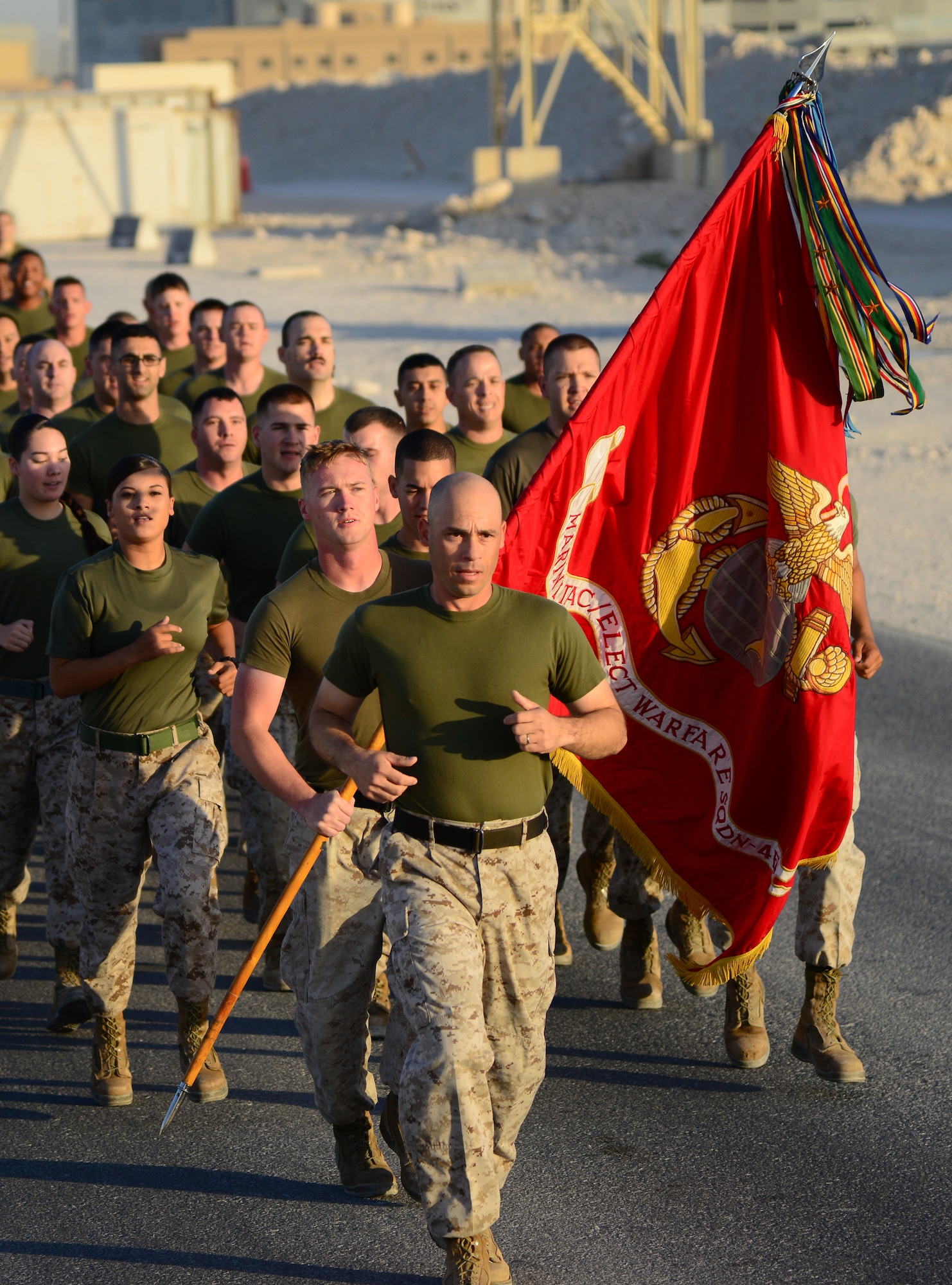 U.S. Marines from the Marine Tactical Electronic Warfare Squadron 4 (VMAQ-4) run in formation for the final two-mile stretch of a 239-mile Marine Corps flag relay run Nov. 10, 2014, at Al Udeid Air Base, Qatar. From Nov. 8 through Nov. 10, Marines from VMAQ-4 ran 239 miles in commemoration of the Marine Corps’ 239th birthday. The 239-miles run was accomplished over a forty-hour timespan. (U.S. Air Force photo by Senior Airman Kia Atkins)