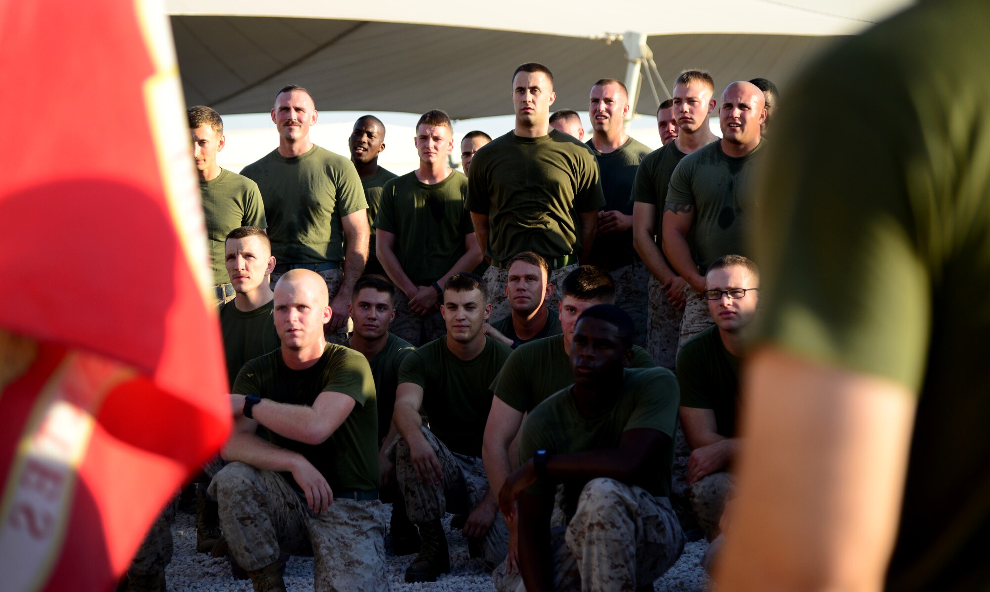 U.S. Marines from the Marine Tactical Electronic Warfare Squadron 4 (VMAQ-4) listen to a speech from their leadership after running the final two-mile stretch of a 239-mile Marine Corps flag relay run Nov. 10, 2014, at Al Udeid Air Base, Qatar. From Nov. 8 through Nov. 10, Marines from VMAQ-4 ran 239 miles in commemoration of the Marine Corps’ 239th birthday. Gunnery Sgt. Brian Taylor, VMAQ-4, participated in the greatest number of laps for the birthday run equaling up to a distance of over 50 miles. (U.S. Air Force photo by Senior Airman Kia Atkins)