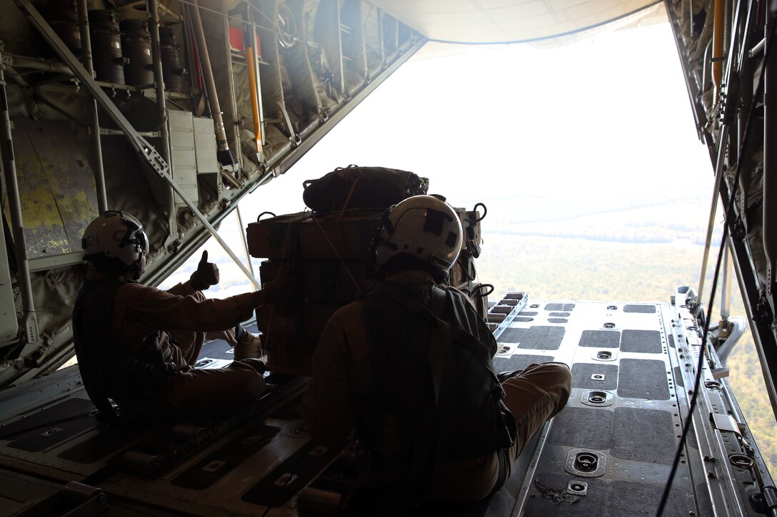 Staff Sgt. Christopher Maxheimer, left, gives a thumb-up to Master Sgt. James R. Holdaway before releasing a container delivery system prior to airborne training at Fort Benning, Ga., Oct. 25, 2014. Both Maxheimer and Holdaway are crew masters with Marine Aerial Refueler Transport Squadron 252.