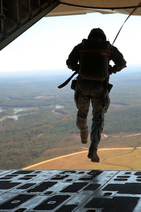 A soldier with the Basic Airborne School, 1st Battalion, 507th Parachute Infantry Regiment, jumps out of a KC-130J Super Hercules at Fort Benning, Ga., Oct. 25, 2014. The Super Hercules belongs to Marine Aerial Refueler Transport Squadron 252 who conducted a training deployment for an upcoming operational deployment with the Special Purpose Marine Air-Ground Task Force Crisis Response. The squadron assisted more than 180 airborne school students from several military branches complete static-line and military free fall jumps.