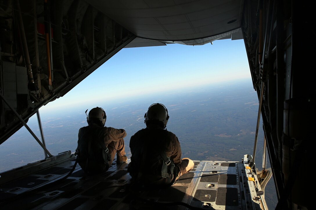 Staff Sgt. Christopher Maxheimer, left, and Gunnery Sgt. John Marsh enjoy the view from the back of a KC-130J Super Hercules at Fort Benning, Ga., Oct. 25, 2014. The Super Hercules was climbing to 13,000 feet to conduct military free fall jumps. Maxheimer and Marsh are crew masters with Marine Aerial Refueler Transport Squadron 252 training for an upcoming operational deployment with the Special Purpose Marine Air-Ground Task Force Crisis Response.