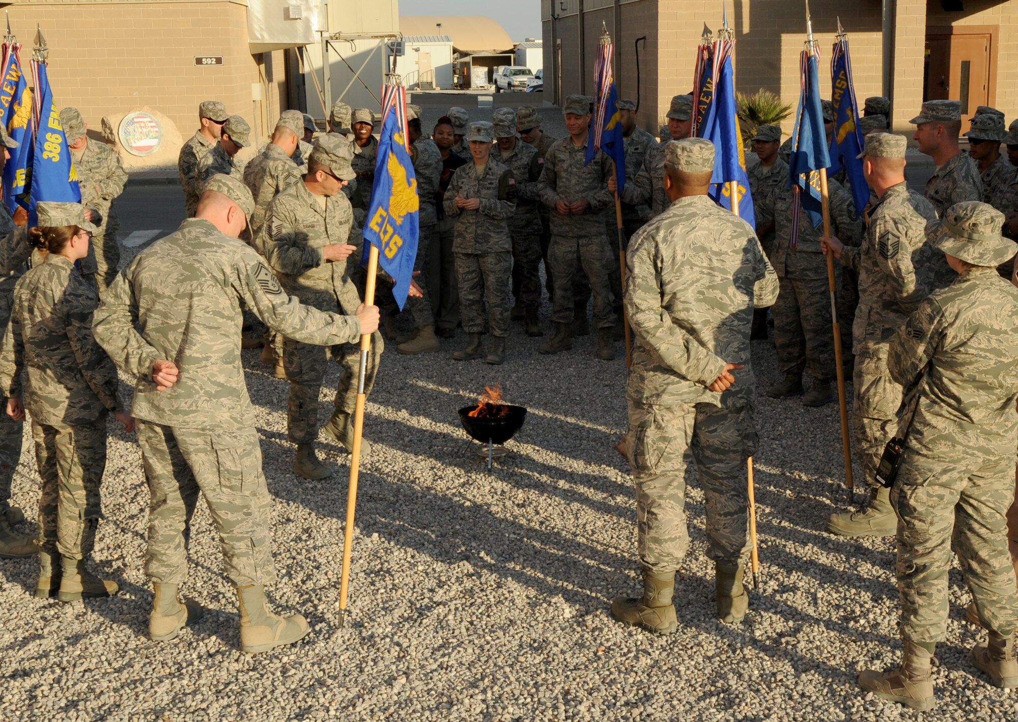 Master Sgt. Eddie Savage (center), 386th Expeditionary Operations Group first sergeant, explains the purpose and meaning of a peace fire ritual during a Native American Heritage Month observance ceremony here Nov. 5, 2014. This year’s Native American Heritage Month theme is, “Native Pride and Spirit: Yesterday, Today and Forever,” and the observance promotes the value of Native American ancestry and traditions. (U.S. Air Force photo by Master Sgt. Eric Petosky/released)