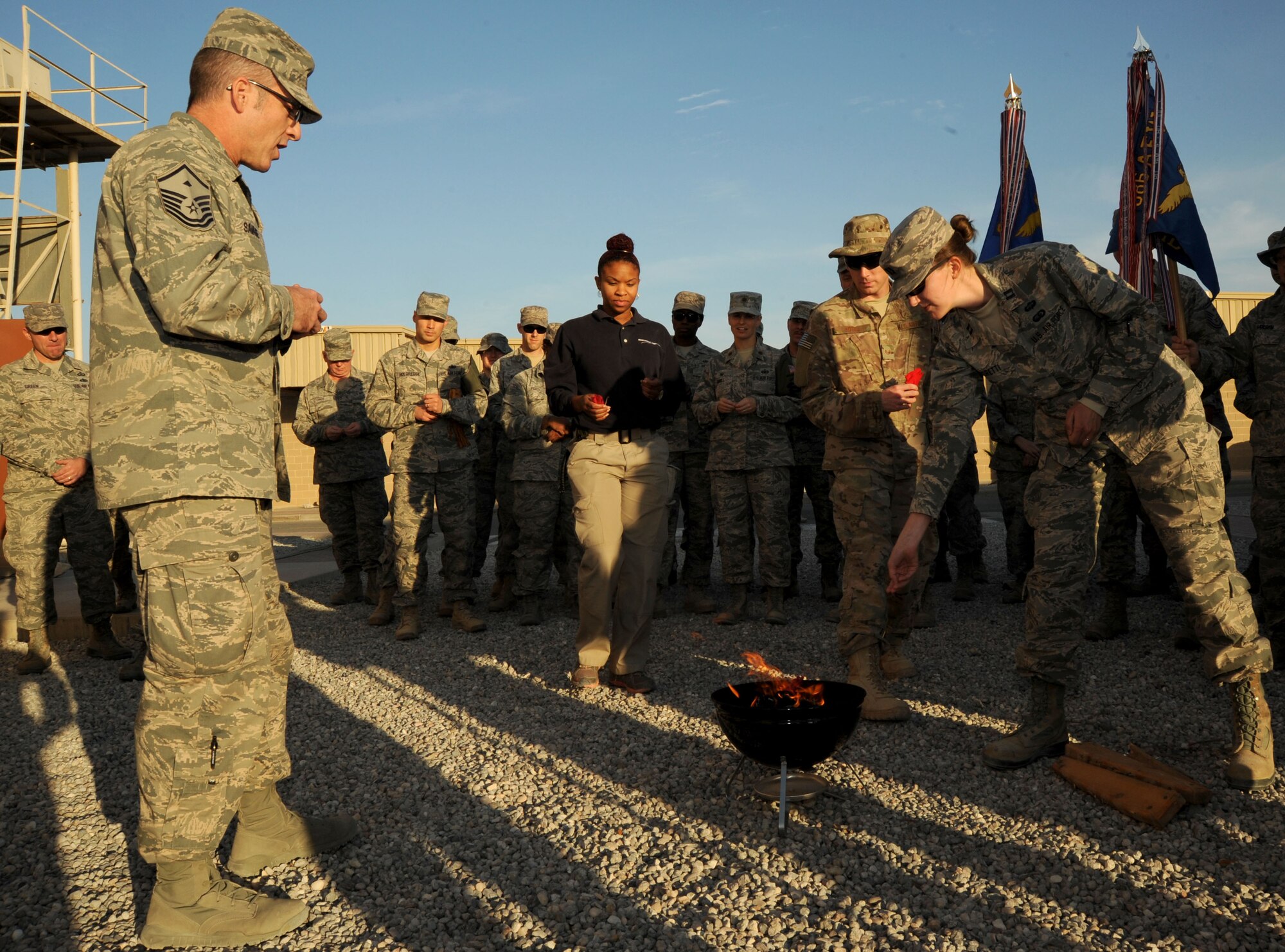 Master Sgt. Eddie Savage (left), 386th Expeditionary Operations Group first sergeant, explains the purpose and meaning of a peace fire ritual during a Native American Heritage Month observance ceremony here Nov. 5, 2014. This year’s Native American Heritage Month theme is, “Native Pride and Spirit: Yesterday, Today and Forever,” and the observance promotes the value of Native American ancestry and traditions. (U.S. Air Force photo by Master Sgt. Eric Petosky/released)