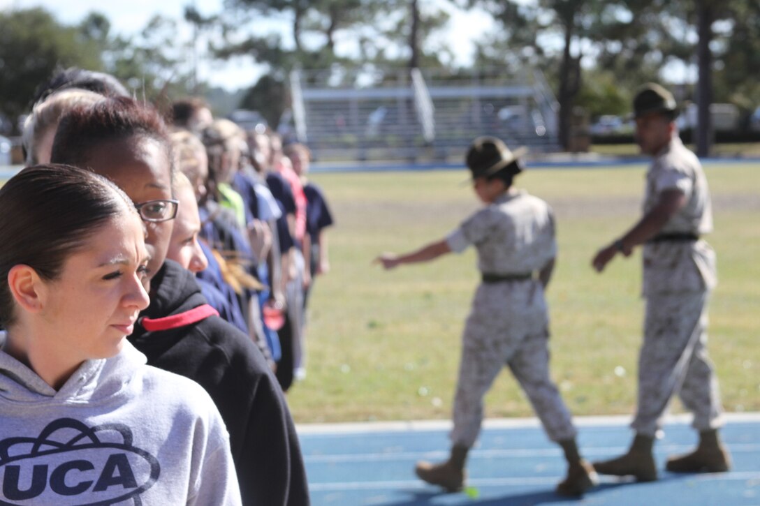 Female poolees of Recruiting Station Jacksonville, Florida, line-up as they prepare to conduct the pull-up bar portion of the initial strength test under the direction of Marine Corps drill instructors during a pool function at Moody Air Force Base, Georgia, Oct. 31, 2014. The young women undergoing training had the rare chance to see firsthand a drill instructor outside of recruit training. The Command of Recruiting Station Jacksonville gathered the female poolees from its recruiting sub-stations, in order to prepare them for future endeavors as they take on the challenge of becoming Marines. The command also had the opportunity to further evaluate the female poolees for potential assignment in previously closed combat arms Military Occupational Specialties.