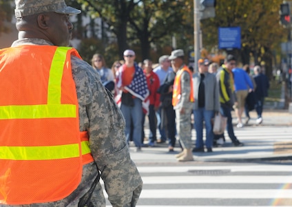 Sgt. Maurice Nichols, 275th Military Police Company, helps the Metropolitan Police Department control traffic in Washington, D.C., Nov. 11, 2014, when the 'Concert for Valor' attracted hundreds of thousands to the capital.  