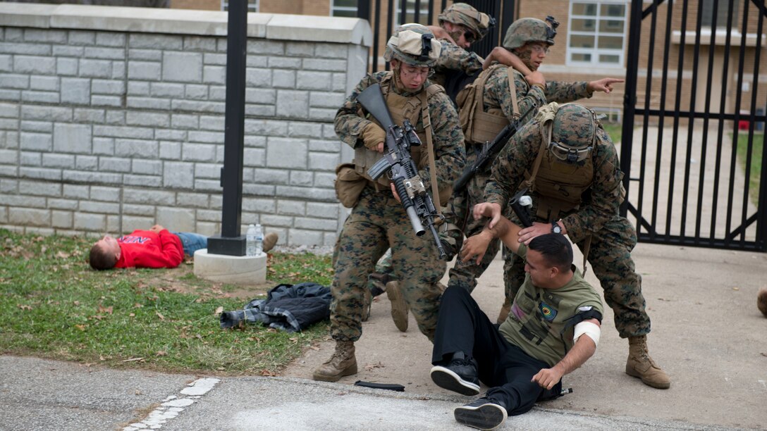 Marines with 2nd Battalion, 8th Marine Regiment, detain a protester during a crisis-response training event Nov. 4 at Muscatatuck Urban Training Center, Indiana as part of Exercise Bold Alligator 2014. During the event, protestors gathered outside the embassy's gates, picketing and rioting, to cause a heighten state of alertness for the Marines proving security at the site.