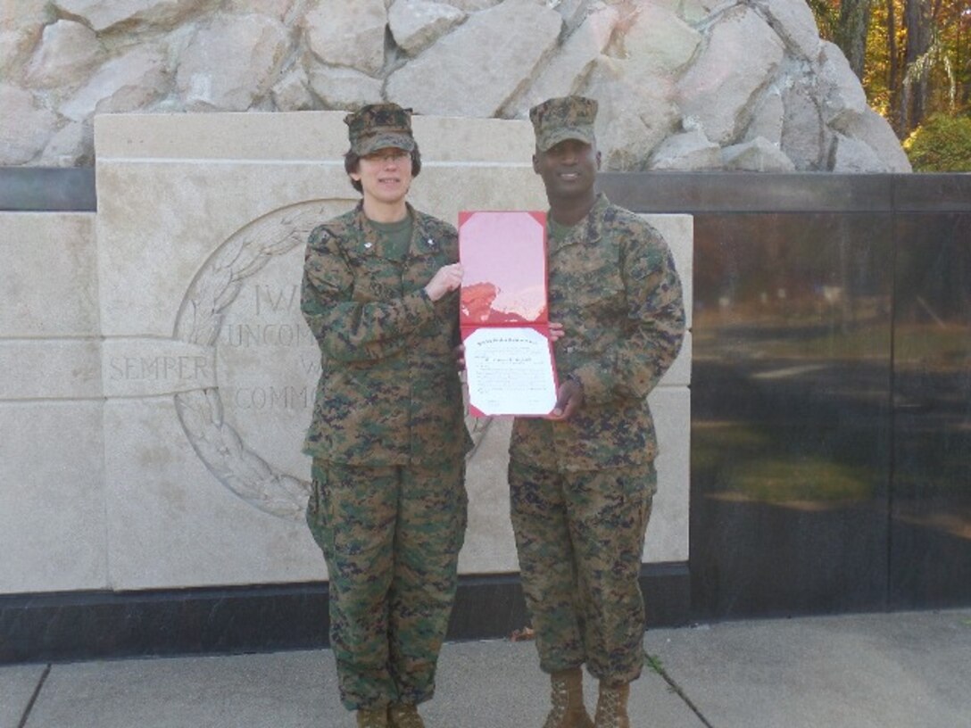 Newly promoted GySgt Casimir and LtCol Elaine Henson.
