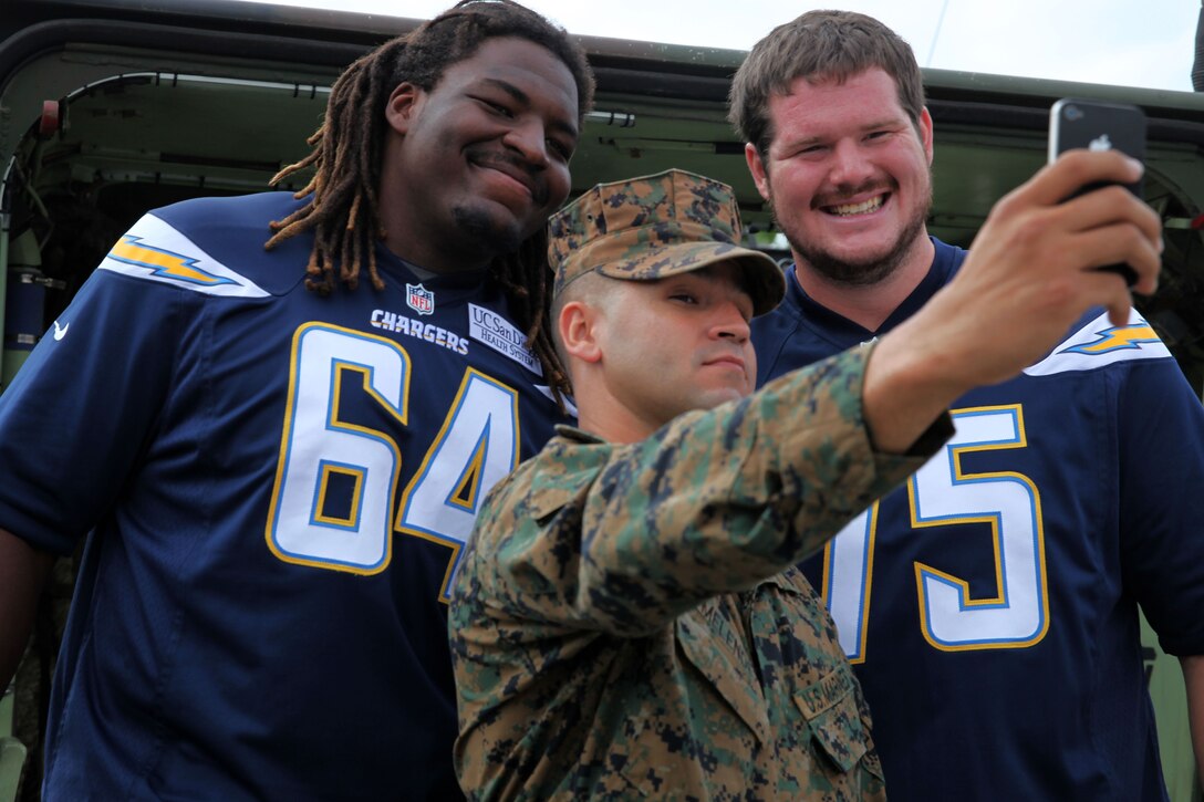 Players and cheerleaders from the NFL Chargers team visit Marines at the Assault Amphibian School Battalion here Nov. 11. The players and cheerleaders volunteered their time to visit the base as part of the Salute to Service military appreciation campaign. While here, the players and cheerleaders met with students and staff at the AAS BN as well as received a tour of the assault amphibian vehicles and the AAV up-gun weapons station simulator.
