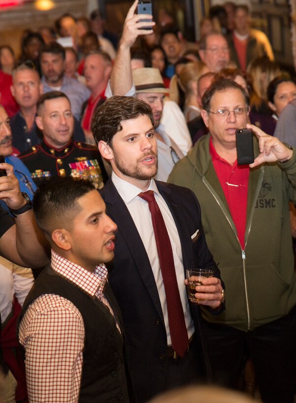 Marines and onlookers stand for the singing of the Marines’ Hymn at Luke Restaurant in New Orleans, Nov. 10, 2014. The restaurant hosts an annual celebration for the Marine Corps birthday. 
