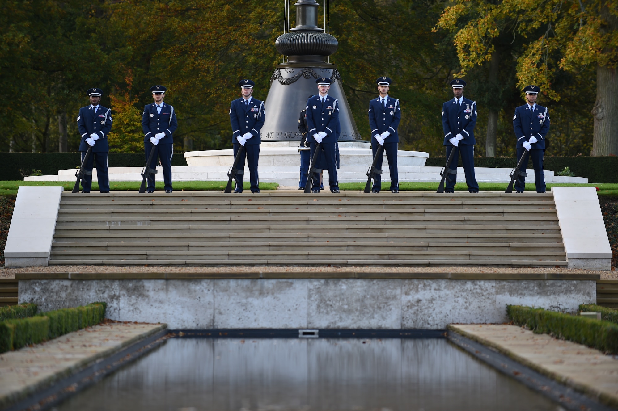 Airmen from the 423rd Air Base Group Honor Guard stand at parade rest prior to firing a volley during a Veterans Day ceremony Nov. 11, 2014, at Cambridge American Cemetery, England. The ceremony honored the 3,812 American Service members buried at the cemetery, along with veterans past and present. (U.S. Air Force photo/Staff Sgt. Jarad A. Denton)