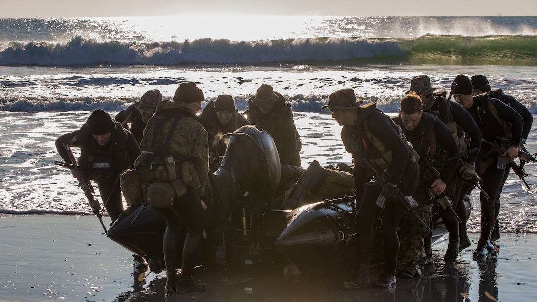 Marines with 2nd Reconnaissance Battalion, 2nd Marine Division drag their Zodiac boats to shore at Onslow Beach, N.C., during beach operations training aboard Camp Lejeune, N.C., Nov. 4, 2014, as part of Exercise Bold Alligator14. Bold Alligator 14 is a scenario-driven exercise designed to improve naval amphibious core competence, increase proficiency in operations ranging from foreign disaster relief to limited force entry, and help grow interoperability with coalition forces. (U.S. Marine Corps photo by Cpl. James R. Smith/Released)