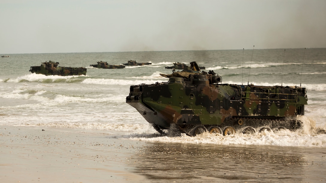 Assault amphibious vehicles with 1st Platoon, Charlie Company, 2nd Assault Amphibian Battalion, 2nd Marine Division drive ashore at Onslow Beach, N.C., during beach operations training aboard Camp Lejeune, N.C., Nov. 4, 2014, as part of Exercise Bold Alligator 14. Bold Alligator 14 is a scenario-driven exercise designed to improve naval amphibious core competence, increase proficiency in operations ranging from foreign disaster relief to limited force entry, and help grow interoperability with coalition forces. (U.S. Marine Corps photo by Cpl. James R. Smith/Released)