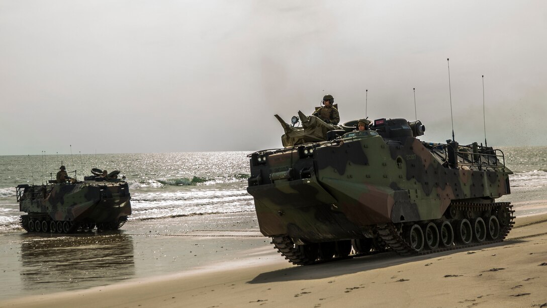 Assault amphibious vehicles with 1st Platoon, Charlie Company, 2nd Assault Amphibian Battalion, 2nd Marine Division drive ashore at Onslow Beach, N.C., during beach operations training aboard Camp Lejeune, N.C., Nov. 4, 2014, as part of Exercise Bold Alligator 14. Bold Alligator 14 is a scenario-driven exercise designed to improve naval amphibious core competence, increase proficiency in operations ranging from foreign disaster relief to limited force entry, and help grow interoperability with coalition forces. (U.S. Marine Corps photo by Cpl. James R. Smith/Released)