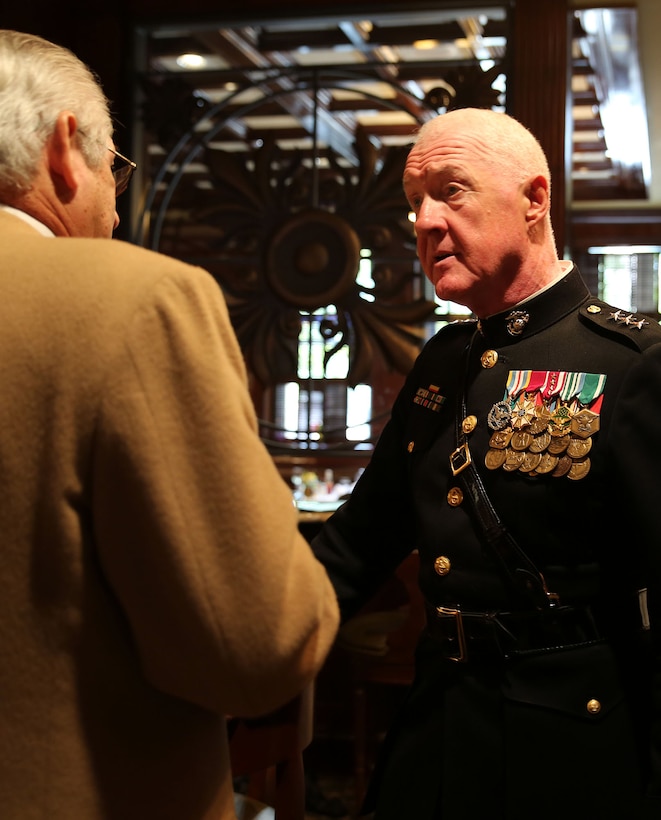 Lt. Gen. Richard P. Mills, commander of Marine Forces Reserve, speaks to Gil Lerma, chairperson of the City Club of Baton Rouge's Veterans Day program, following Mills' speech to veterans at the City Club of Baton Rouge in downtown Baton Rouge, La., Nov. 11, 2014. The general expressed appreciation for support of local veterans and spoke of the great contributions Marines have made to the world in wartime and peace.