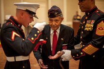 Private First Class James E. Swanson, Jr. receives a slice a cake from First Sergeant Rudolph Carter during the Chemical Biological Incident Response Force's celebration of the 239th Marine Corps Ball, November 8, 2014 in Arlington, Virginia. Carter, 96, was the oldest Marine present at the ball and one of the original Montford Point Marines who attended boot camp in 1942. Swanson, 18, was the youngest Marine present. The two shared a piece of cake, signifying the passing of experience and knowledge from the old to the young of our Corps.