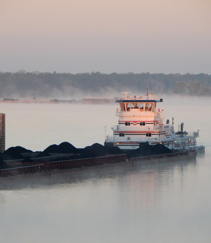 Steam rises off the Ohio River as coal barges move through J.T. Myers Locks and Dam. 