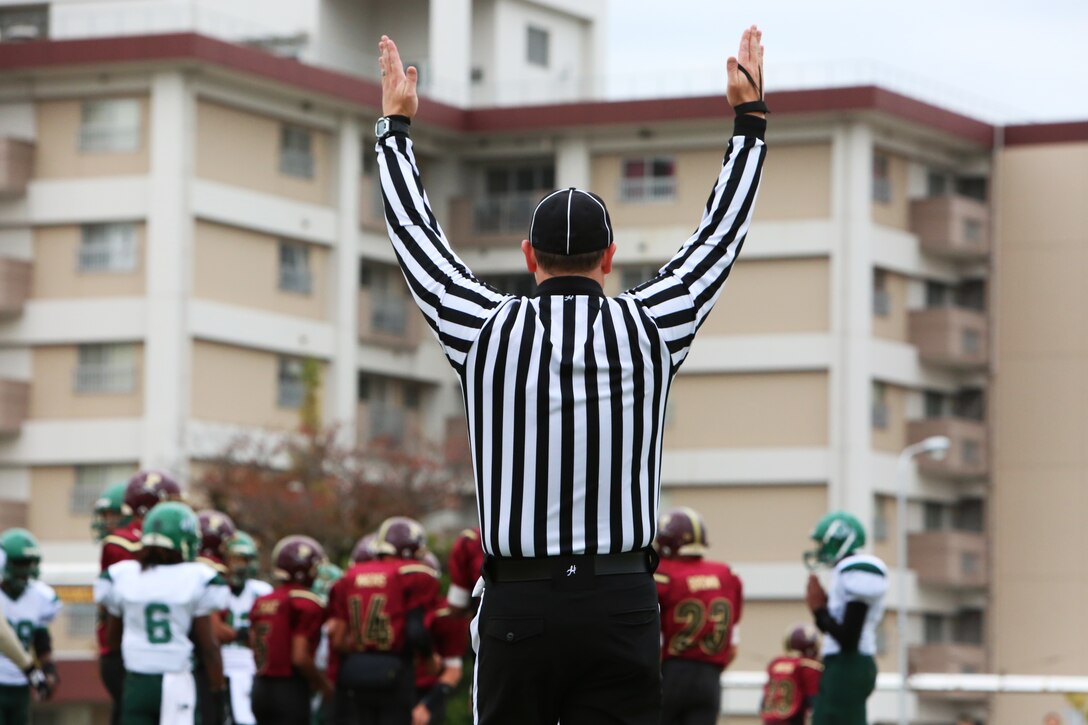 A referee confirms a Matthew C. Perry Samurai touchdown, one of the eight they would score against the Deagu Warriors during the 2014 Department of Defense Dependents Schools Far East Division II Football Championship Game at the Matthew C. Perry High School football field aboard Marine Corps Air Station Iwakuni, Japan, Nov. 8, 2014. The Warriors still prevailed, winning 60-50, to claim their fourth Division II football title.