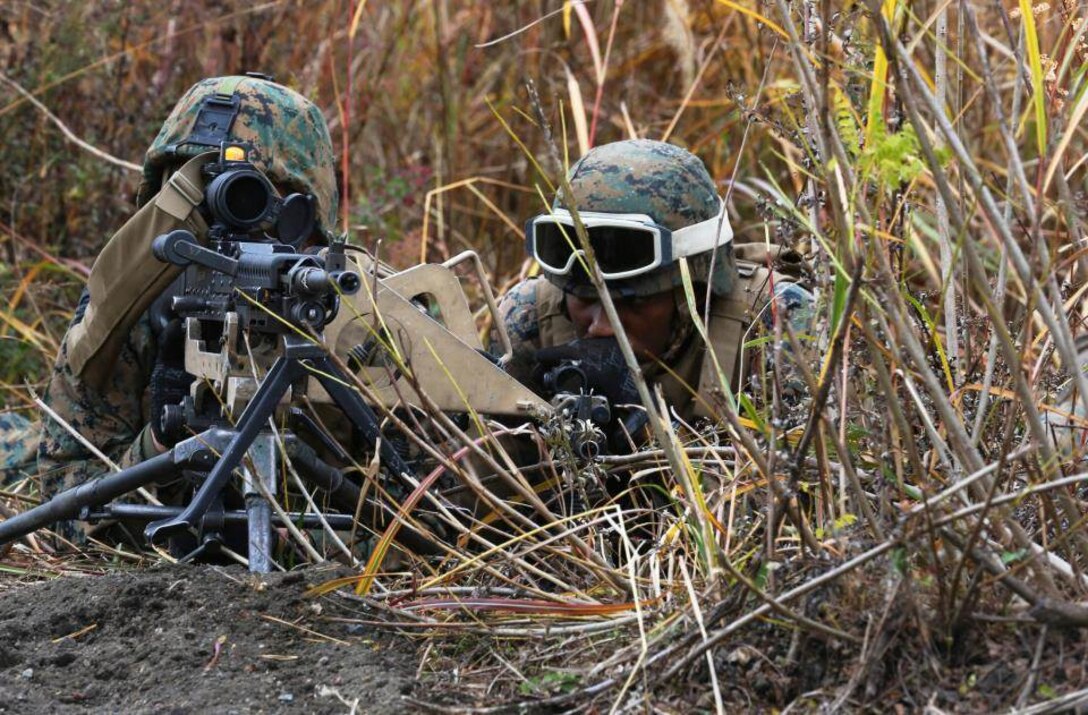 U.S. Marine Corps Lance Cpl. Brett T. Hampton, left, maintenance management specialist and Cpl. Daniel R. Roka, maintenance quality control chief, both with 3d Battalion, 12th Marines (3/12) post security on a road during a training event at Combined Arms Training Center Camp Fuji, Shizuoka, Japan, Nov. 2, 2014. The Marines of 3/12 are taking part in Artillery Relocation Training Program 14-3, a relocation exercise sponsored by Japan in order to enhance combat readiness and support the U.S.-Japan Treaty of Mutual Cooperation and Security. (U.S. Marine Corps photo by MCIPAC Combat Camera Lance Cpl. Sergio RamirezRomero/ Released)
