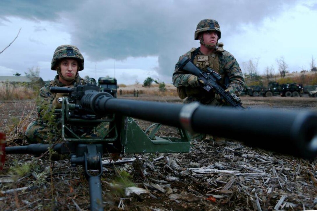U.S. Marine Corps Lance Cpl. Anthony M. Aizpuro, left, and Cpl. Michael Stotko, both motor transportation mechanics with 3d Battalion, 12th Marines post security on a road leading to Landing Zone Raven during a training event at Combined Arms Training Center Camp Fuji, Shizuoka, Japan, Nov. 2, 2014. The Marines of 3/12 are taking part in Artillery Relocation Training Program 14-3, a relocation exercise sponsored by Japan in order to enhance combat readiness and support the U.S.-Japan Treaty of Mutual Cooperation and Security.  (U.S. Marine Corps photo by MCIPAC Combat Camera Lance Cpl. Sergio RamirezRomero/ Released)
