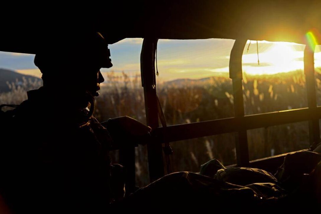 U.S. Marine Corps Cpl. Carlos M. Lora-Moreno, an embark clerk with 3d Battalion, 12th Marines (3/12) rides in the back of an medium tactical vehicle replacement during a training event at Combined Arms Training Center Camp Fuji, Shizuoka, Japan, Nov. 3, 2014. The Marines of 3/12 are taking part in Artillery Relocation Training Program 14-3, a relocation exercise sponsored by Japan in order to enhance combat readiness and support the U.S.-Japan Treaty of Mutual Cooperation and Security.  (U.S. Marine Corps photo by MCIPAC Combat Camera Lance Cpl. Sergio RamirezRomero/ Released)
