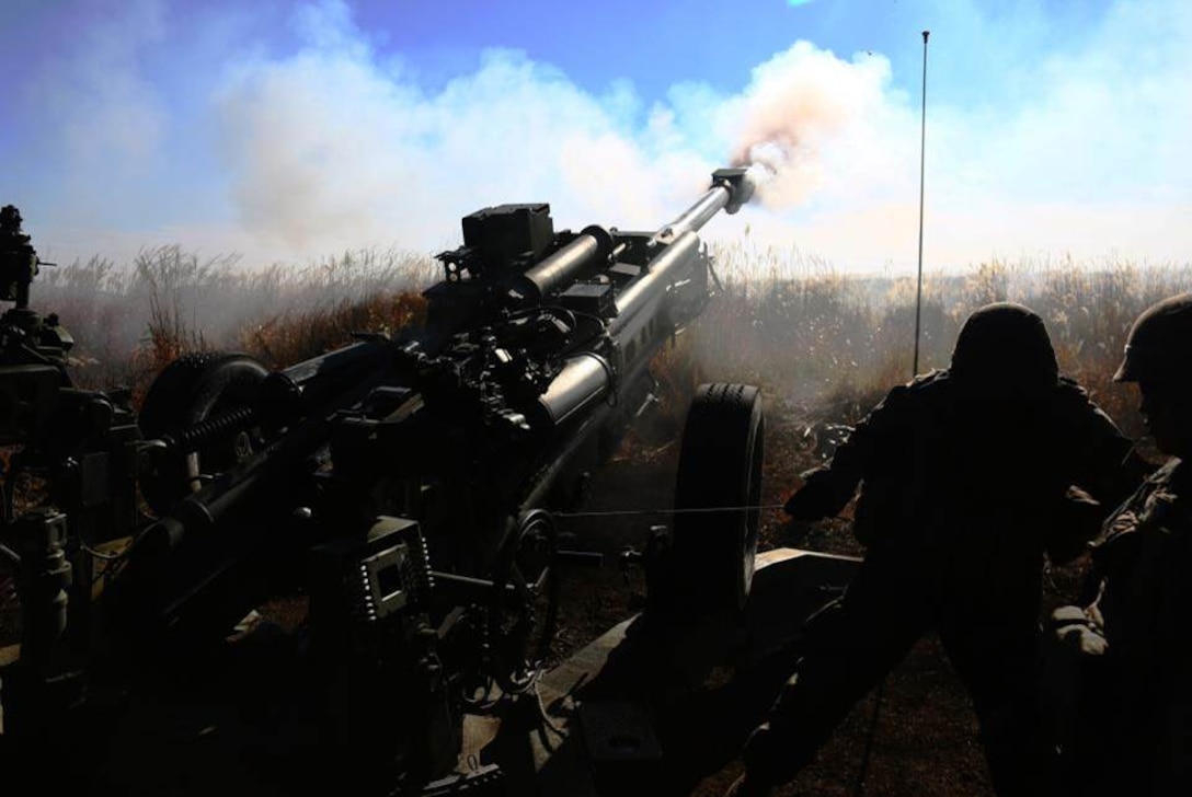 U.S. Marines with Bravo Battery, 3d Battalion, 12th Marines (3/12) fire a M777 towed 155mm howitzer during a training event at Combined Arms Training Center Camp Fuji, Shizuoka, Japan, Nov. 4, 2014. The Marines of 3/12 are taking part in Artillery Relocation Training Program 14-3, a relocation exercise sponsored by Japan in order to enhance combat readiness and support the U.S.-Japan Treaty of Mutual Cooperation and Security.  (U.S. Marine Corps photo by MCIPAC Combat Camera Lance Cpl. Sergio RamirezRomero/ Released)
