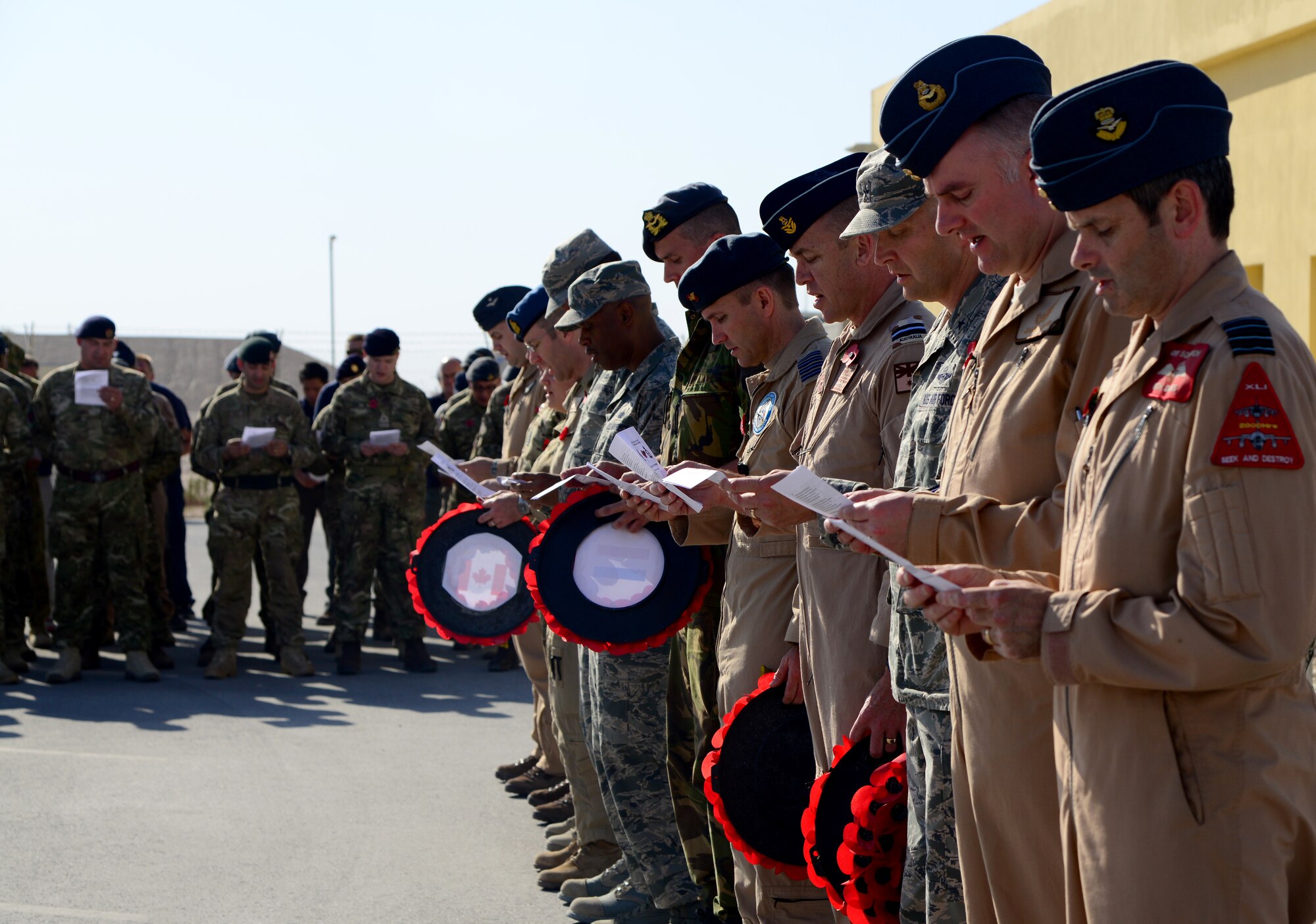 Military coalition partners stationed at Al Udeid Air Base, Qatar, participate in a Remembrance Day service here, Nov. 11, 2014. Members of many different branches of service from varying countries honored those who serve and have served the military in joint Remembrance and Veteran’s Day ceremonies. (U.S. Air Force photo by Senior Airman Kia Atkins)